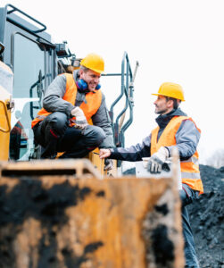 construction workers talking on site.