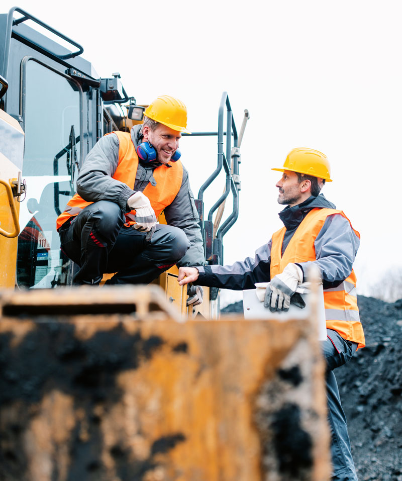 construction workers talking on site.